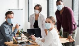 working-team-office-during-pandemic-wearing-face-masks_23-2148666331